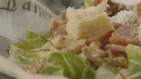 Close-up Caesar salad sprinkled with parmesan. Video in slow motion Full HD Stock Footage 104402095