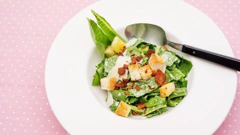 Close up of caesar salad on a table. Stock Photos