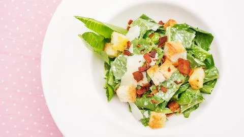 Close up of caesar salad on a table. Stock Photos