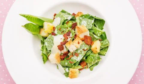 Close up of caesar salad on a table. Stock Photos