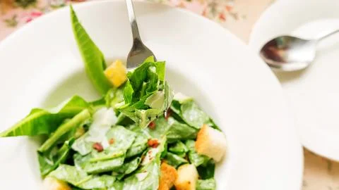 Close up of caesar salad on a table. Stock Photos