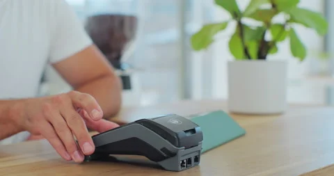 Close up in the cafe man makes coffee for a customer who pays by contactless Stock Footage 203895591