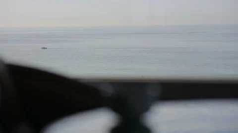 Close up in a cafe with panoramic views of atlantic ocean. Cup, fish boat with a Vidéo 55910993