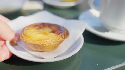 Close up cafe table as hand serves plate with pastel de nata pastry in Portugal Stock Footage 289677663