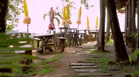 Close Cafe on tropical beach, veranda with closed umbrellas. 4K Video stock 64758424