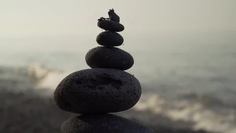 Close up of cairn at the beach with bugs on top Stock Footage 128364852