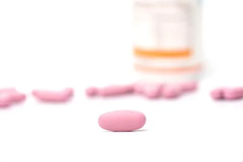 Close-up calcium tablets on white background with bottle .Calcium  Maintain S Stock Photos