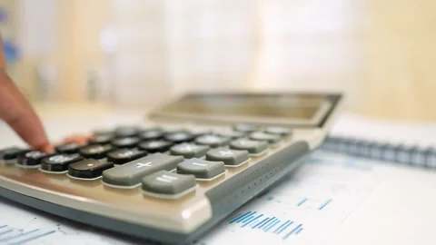 Close-Up of Calculator and Documents on Desk, Close-up of a person using a .. Stock Footage 317736905
