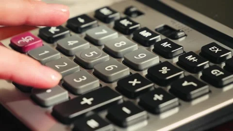 Close up of calculator on a desk, person creating a financial budget Stock Footage 325725599