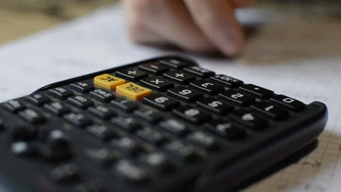 Close-up calculator with student study math in the background. Stock Footage 223132677