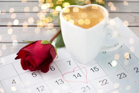 Close up of calendar, heart, coffee and red rose Stock Photos
