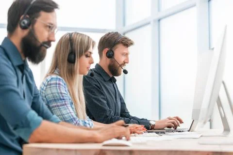 Close up. call center operators work in a modern office. Stock Photos