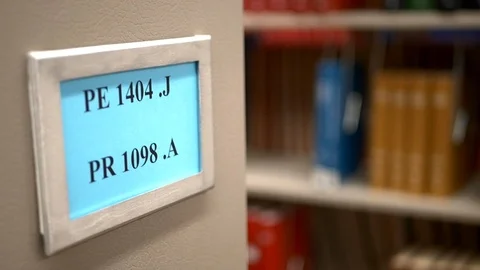 Close-up of call numbers on library stacks of books. Video stock 99999559