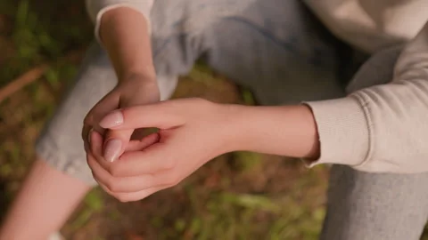 Close-Up of Calm Hands Clasped in Reflective Pose with Autumn Foliage Background 스톡 동영상 292819606
