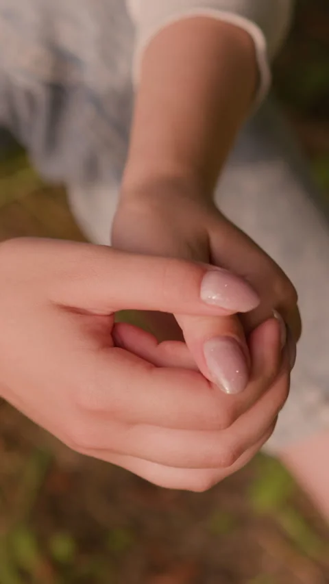 Close-Up of Calm Hands Clasped in Reflective Pose with Autumn Foliage Background 스톡 동영상 310412502
