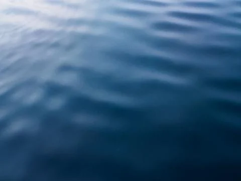 Close up of calm ocean water featuring smooth ripples Stock Photos