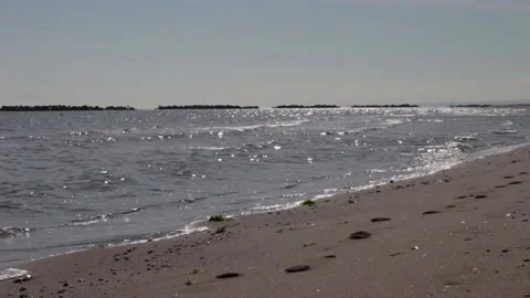 Close-up of calm sea waves. In the background the rocks. A relaxing day Stock Footage 239310530