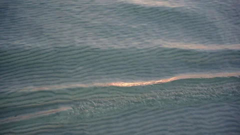 Close-up of Calm Sea Waves at Sunset, Soft Evening Light Reflecting on Water Stock Footage 327796328