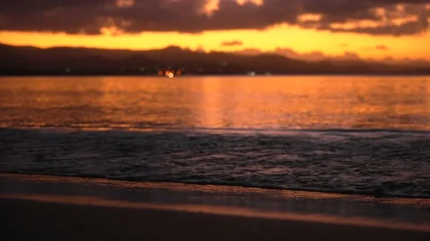 Close-up of calm waves on the sand at sunset. Stock Footage 169225895