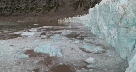 Close up of calving glacier disappearing ice front floating away and melting Stock Footage 167516014