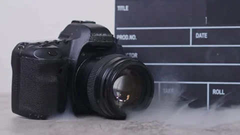 Close-up of camera and chalkboard with smoky for content creation and Stock Footage 337454302