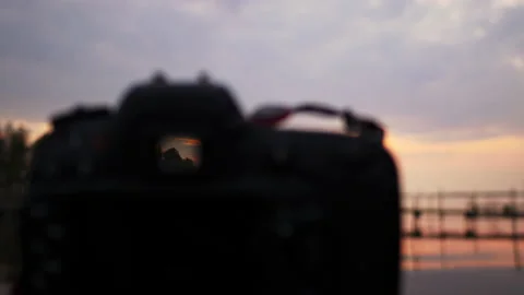 Close up of  camera with beautiful sunset and lake background in the evening Video stock 170449527