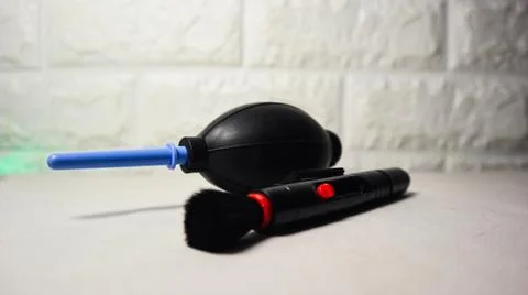 Close-up of a camera cleaning kit featuring a black air blower with a blue .. Stock Photos