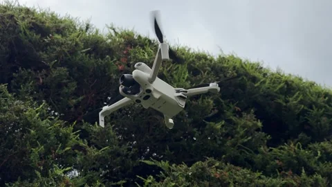 Close Up Camera Drone Flying in Mid Air with Propellers and Stabilized Gimbal Stock Footage 345170445