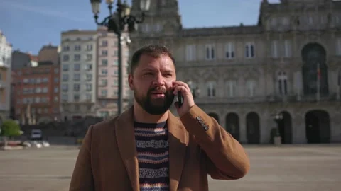 A close-up camera flew around a man with a beard talking on the phone in the Stock Footage 221408335