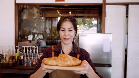 Close-up camera in front bakery owner handing out tray with small croissant.. Stock Footage 244968969