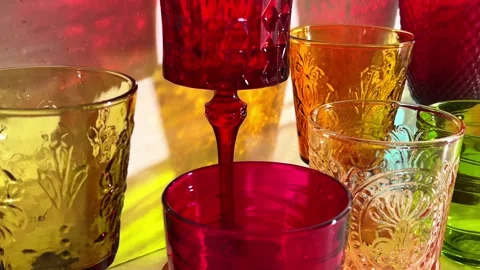 Close camera glide past a green embossed goblet and colorful glasses for ta.. Stock Footage 340034656