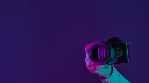 Close Up of Camera in Hand with Colorful Lighting Видео 334107796