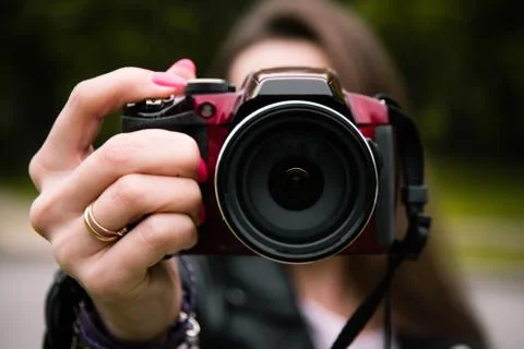 A close-up camera is held in the hands Photos