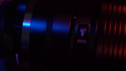 Close up camera lens function button cinematic red/blue light swipe Stock Footage 128490453