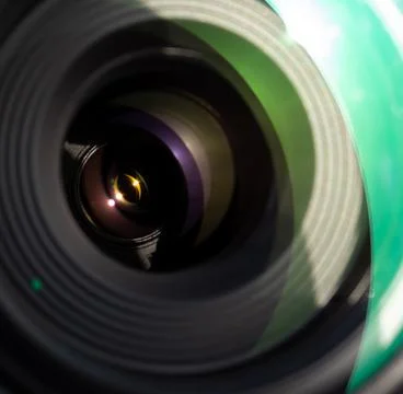 Close up of a camera lens, with glass elements reflecting bright &amp; sharp light. Stock Photos