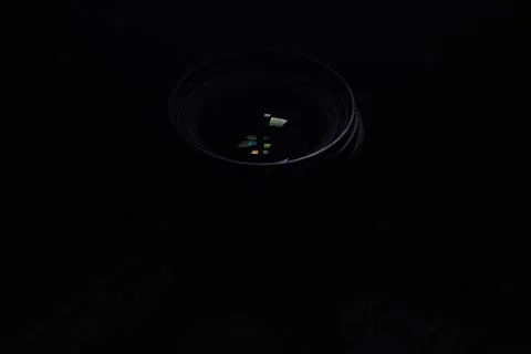Close-Up of a Camera Lens in Low Light Setting Highlighting Reflections Stock Photos