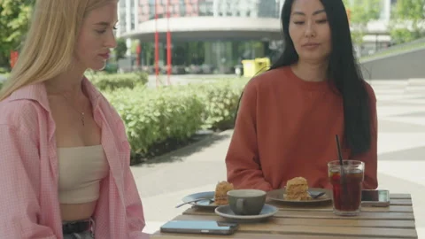 Close Up Camera Movement Capturing Friendly Conversation At Outdoor Cafe Stock Footage 313843282