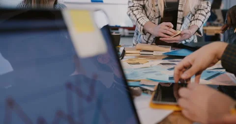 Close-up camera moves around multiethnic team collaborating behind office table Stock Footage 106156331