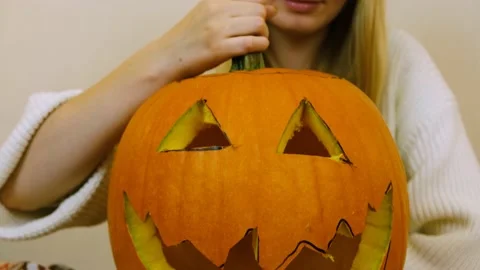 Close-up. The camera moves up. The camera pans to a pumpkin. Halloween. 4k. Stock Footage 219260211
