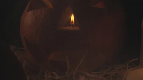 Close up camera moving passing through pumpkin with candle. Carved pumpkin for Stock Footage 139088883