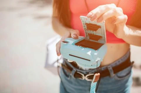 Close up of camera with opened back. Girl has done it. She is holding camera in Фото