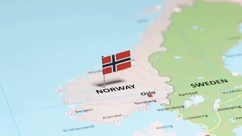 Close up camera pan of Norway flag pin on map Stock Footage 333484931