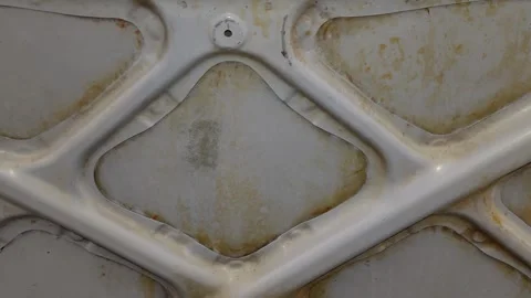 A close up camera pan reveals rust stains inside car hood Stock Footage 335834294