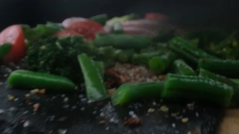 Close-up camera slowly moving between knife cuts vegetables and raw chicken Stock Footage 130997609