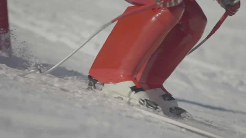 Close-up camera tracking red skier's feet Video stock 346056194
