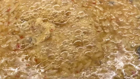 A close-up camera watches the boiling process of an appetizing risotto. Stock Footage 150183884
