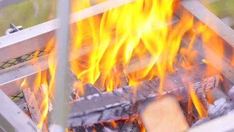 Close-up of a campfire burning during the day in nature. 4K Stock Footage 328627848