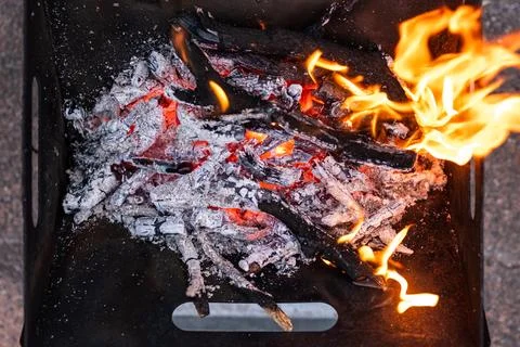 Close up of campfire, fire pit filled with burnt wood, flames. Fire burning.. Stock Photos