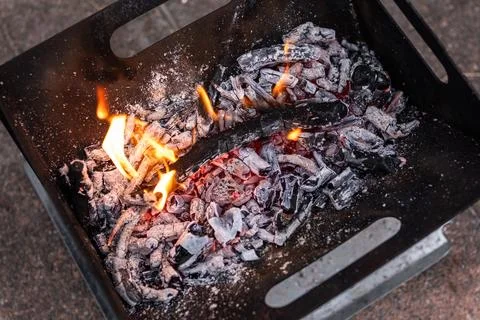 Close up of campfire, fire pit filled with burnt wood, flames. Fire burning.. Stock Photos