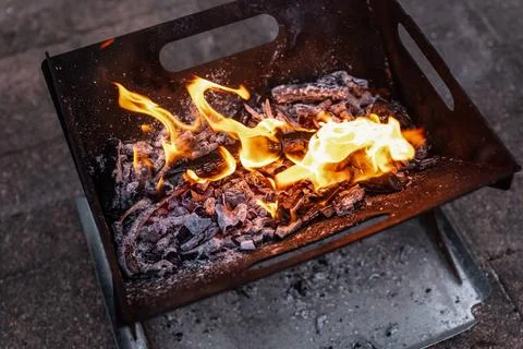 Close up of campfire, fire pit filled with burnt wood, flames. Fire burning.. Stock Photos